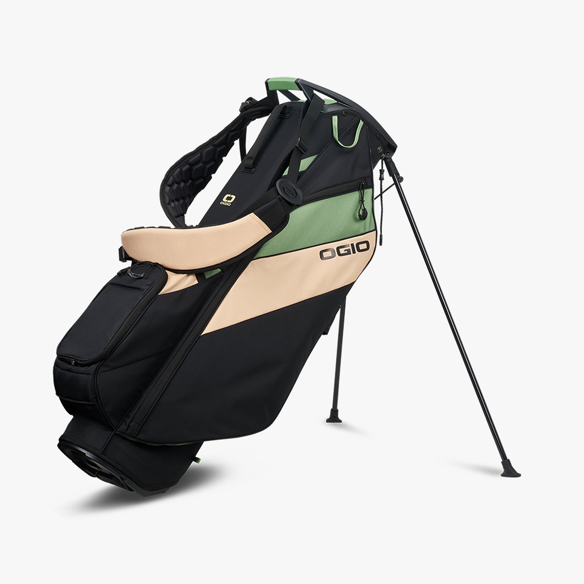 OGIO branded black golf stand bag with green and beige accents, featuring multiple pockets and the logo visible on the top.