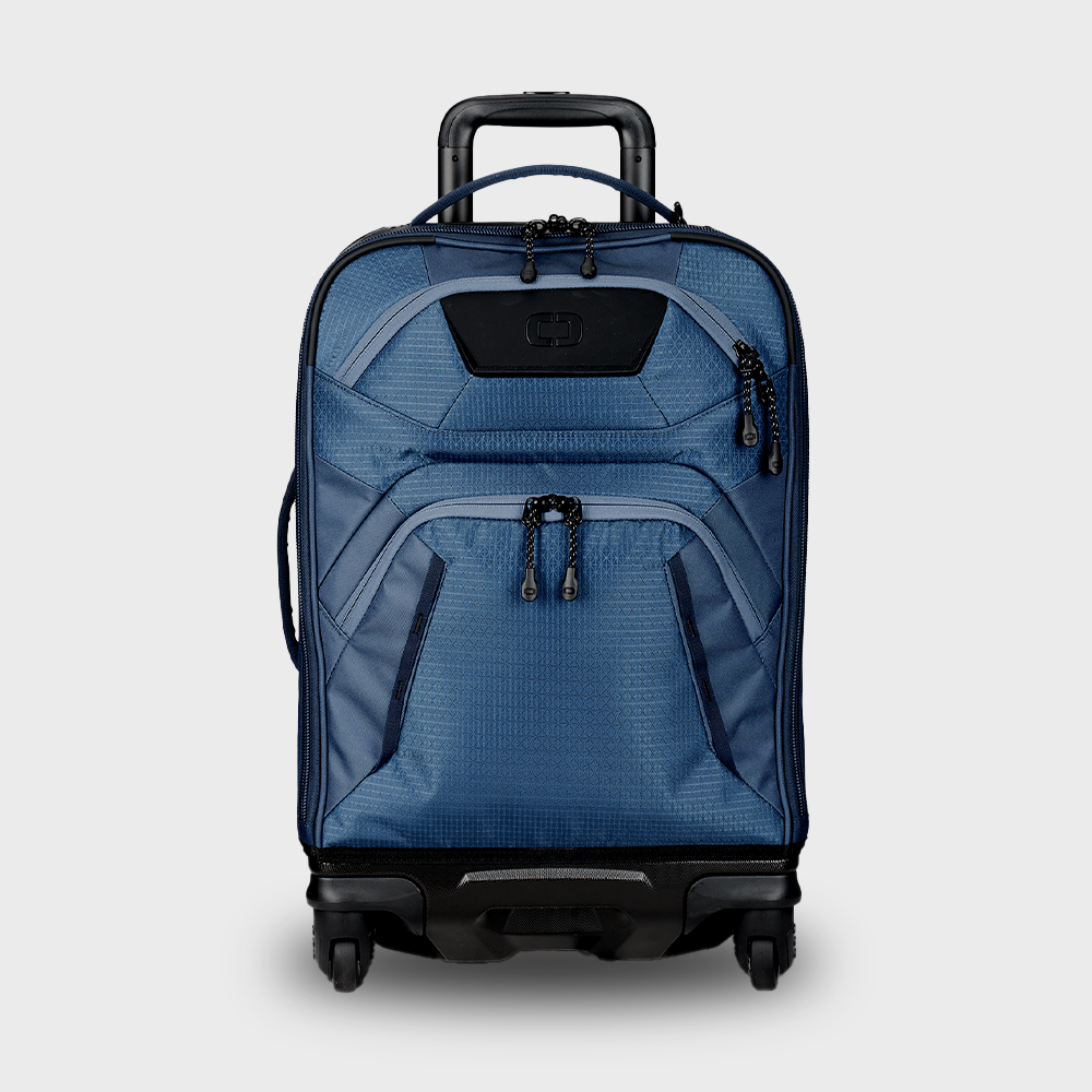 A navy blue carry-on luggage bag with a telescopic handle, top and side carry options, and four wheels.