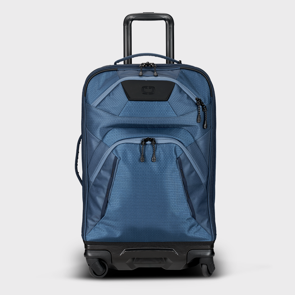 A navy blue Renegade Pro 26 inch luggage with a telescopic handle, top and side carry options, and four wheels.