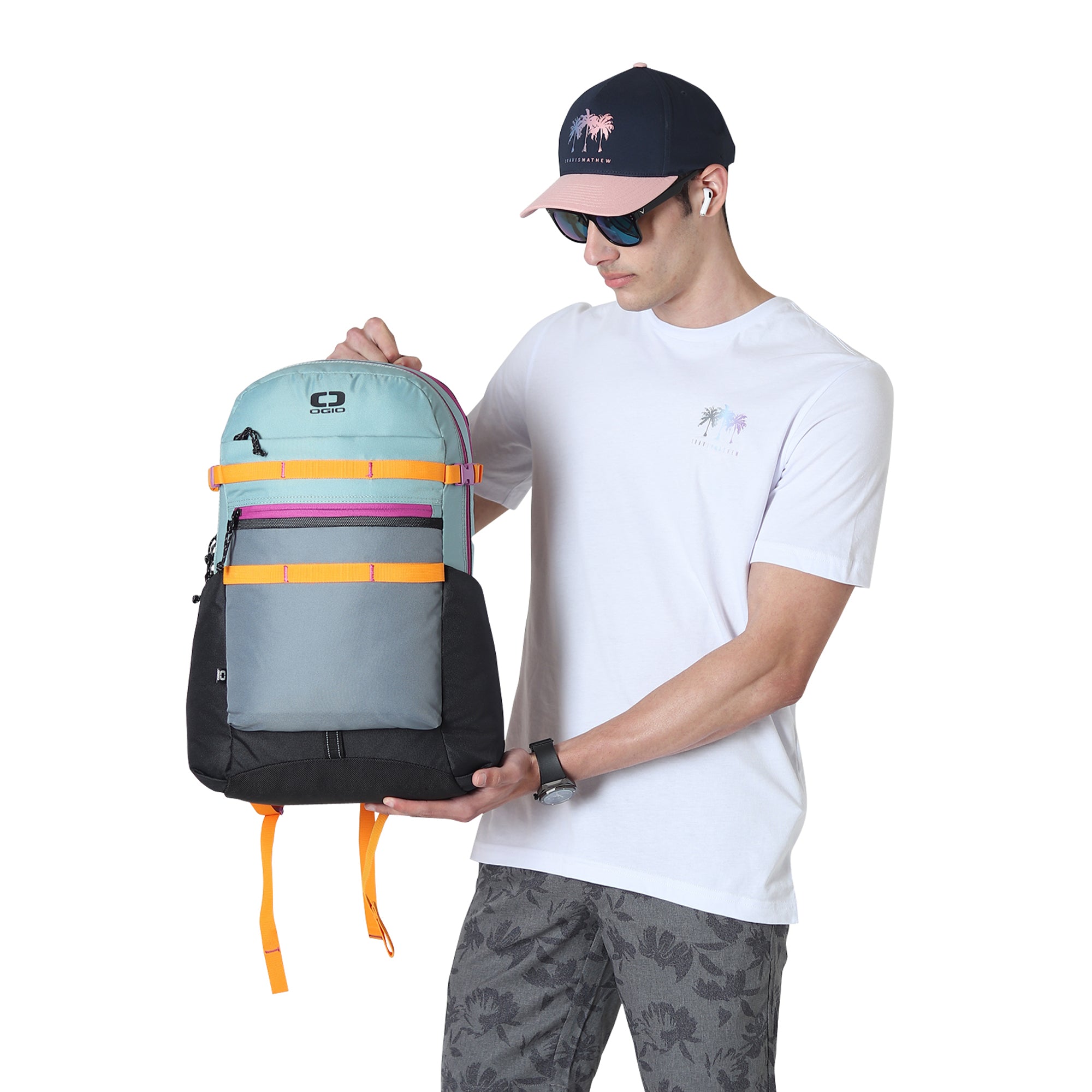 Man in white t-shirt carrying OGIO Alpha 20L Backpack in Mineral Blue