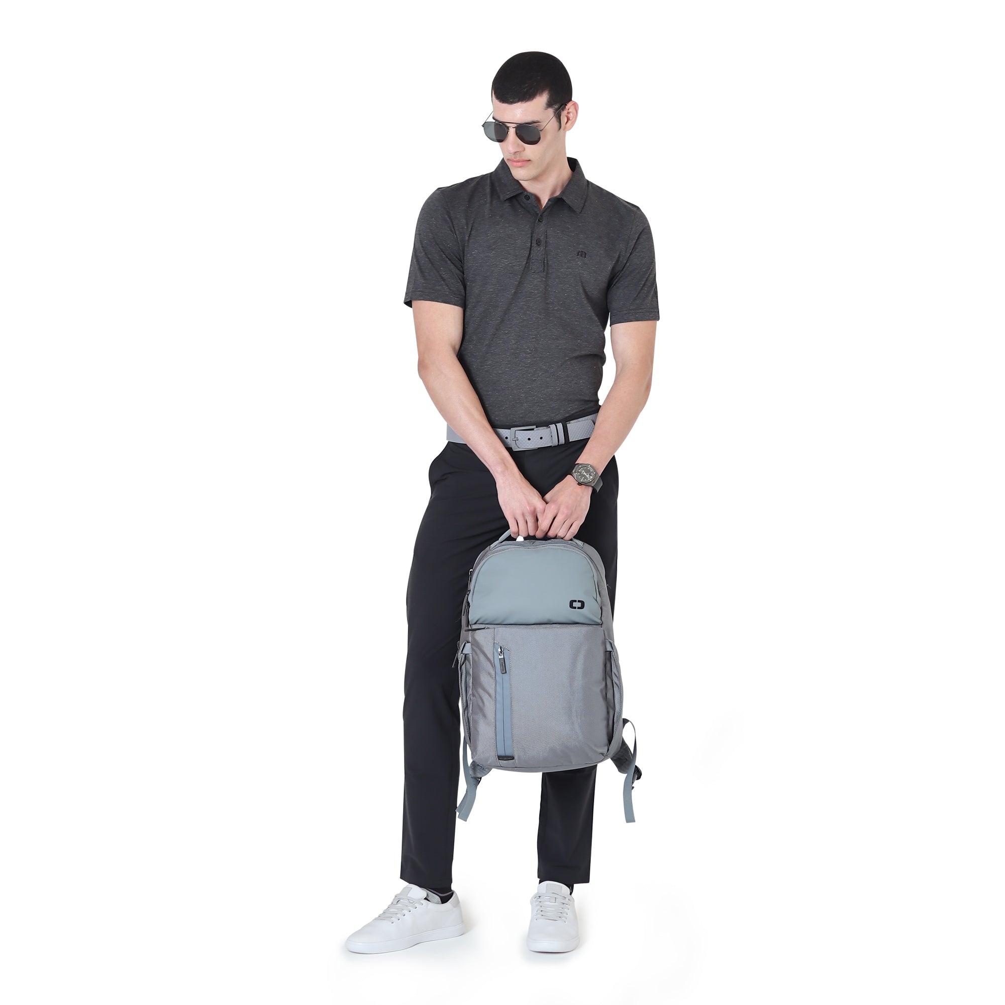 Man holding OGIO Stormy Weather backpack with casual black outfit and sunglasses