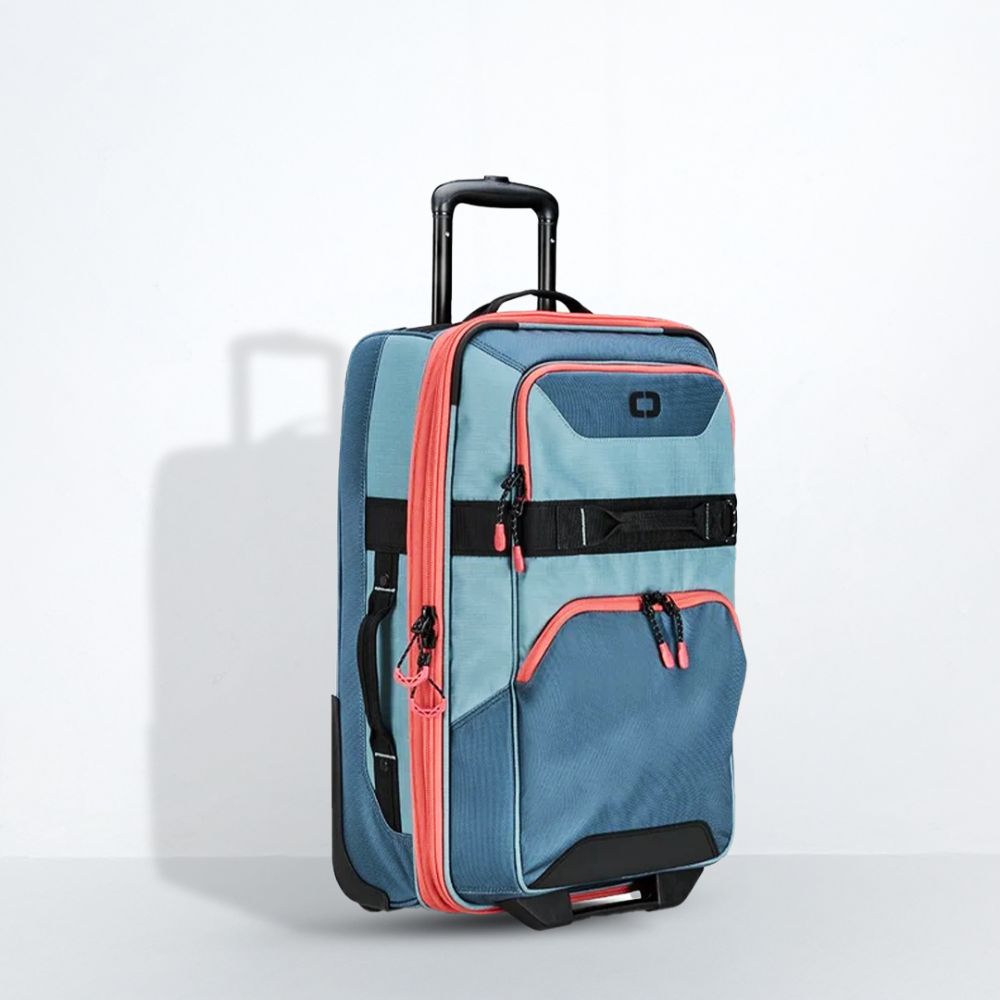 Blue and pink suitcase with wheels on a light gray background