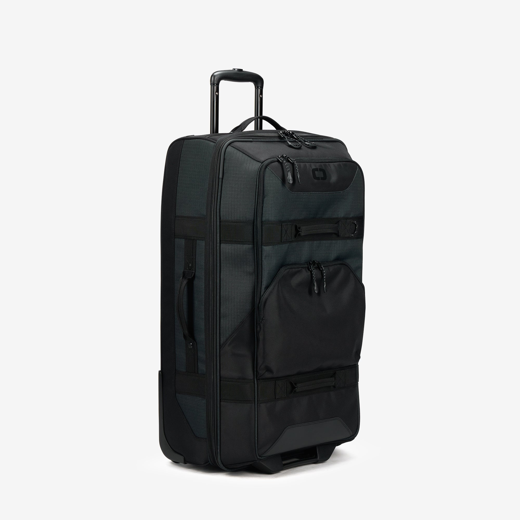 A black OGIO Alpha Terminal checked luggage bag with a telescopic handle, top and side carry options, and multiple compartments.