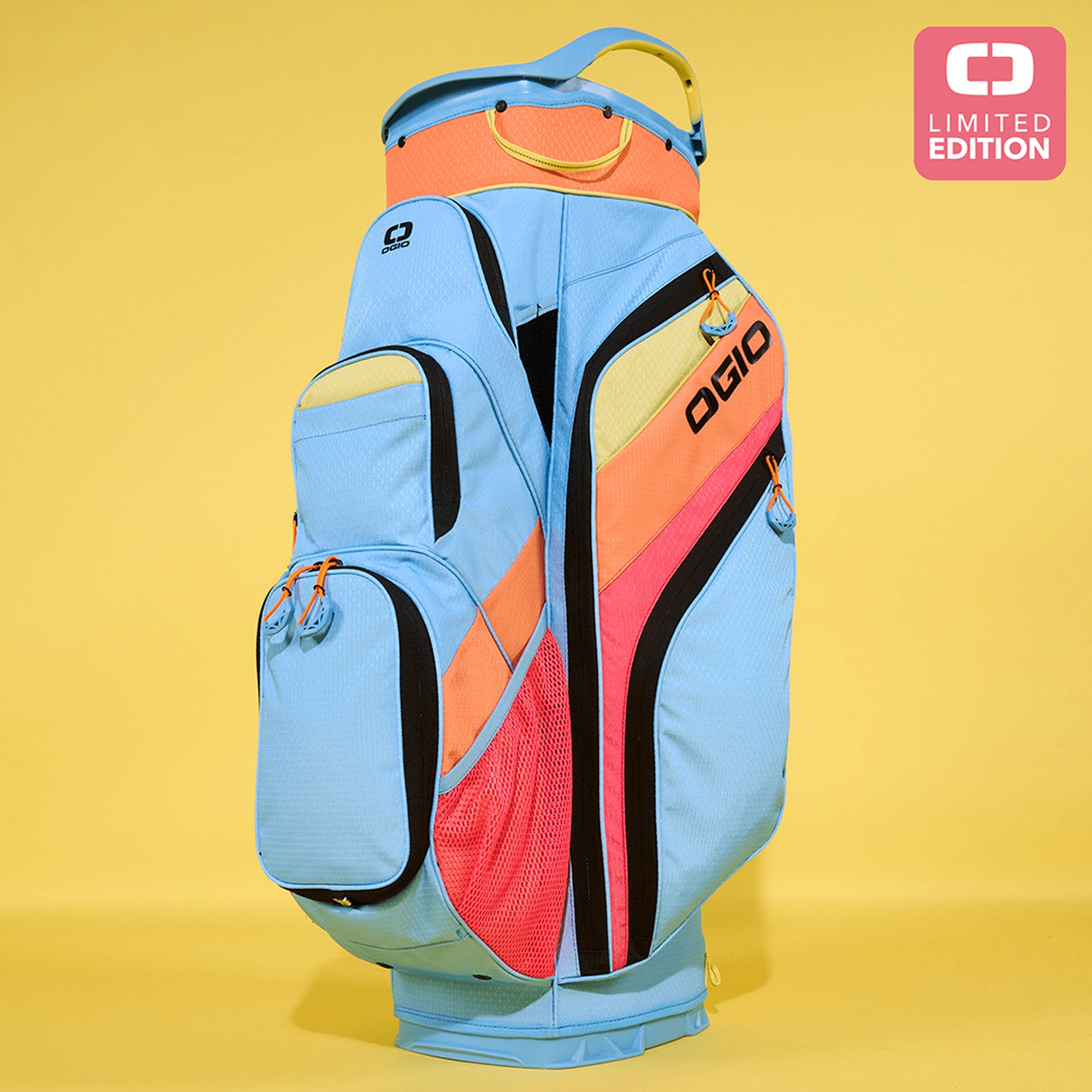 A multicolored golf cart bag with blue, orange, and white accents, featuring multiple pockets and the OGIO brand logo on the side, displayed against a yellow background with a 'Limited Edition' label.