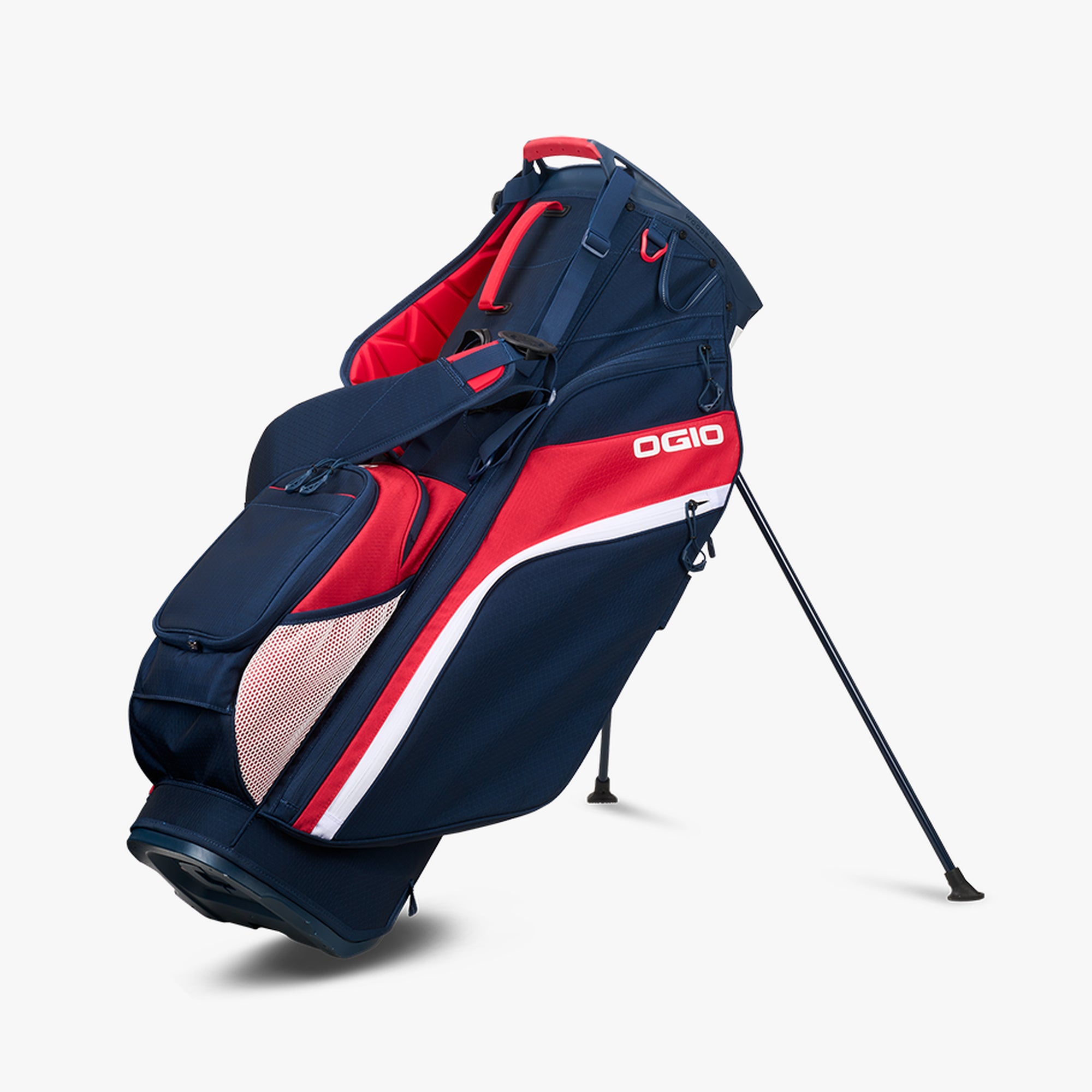 OGIO branded golf bag in red, white, and blue colors with stand mechanism, pockets, and straps.